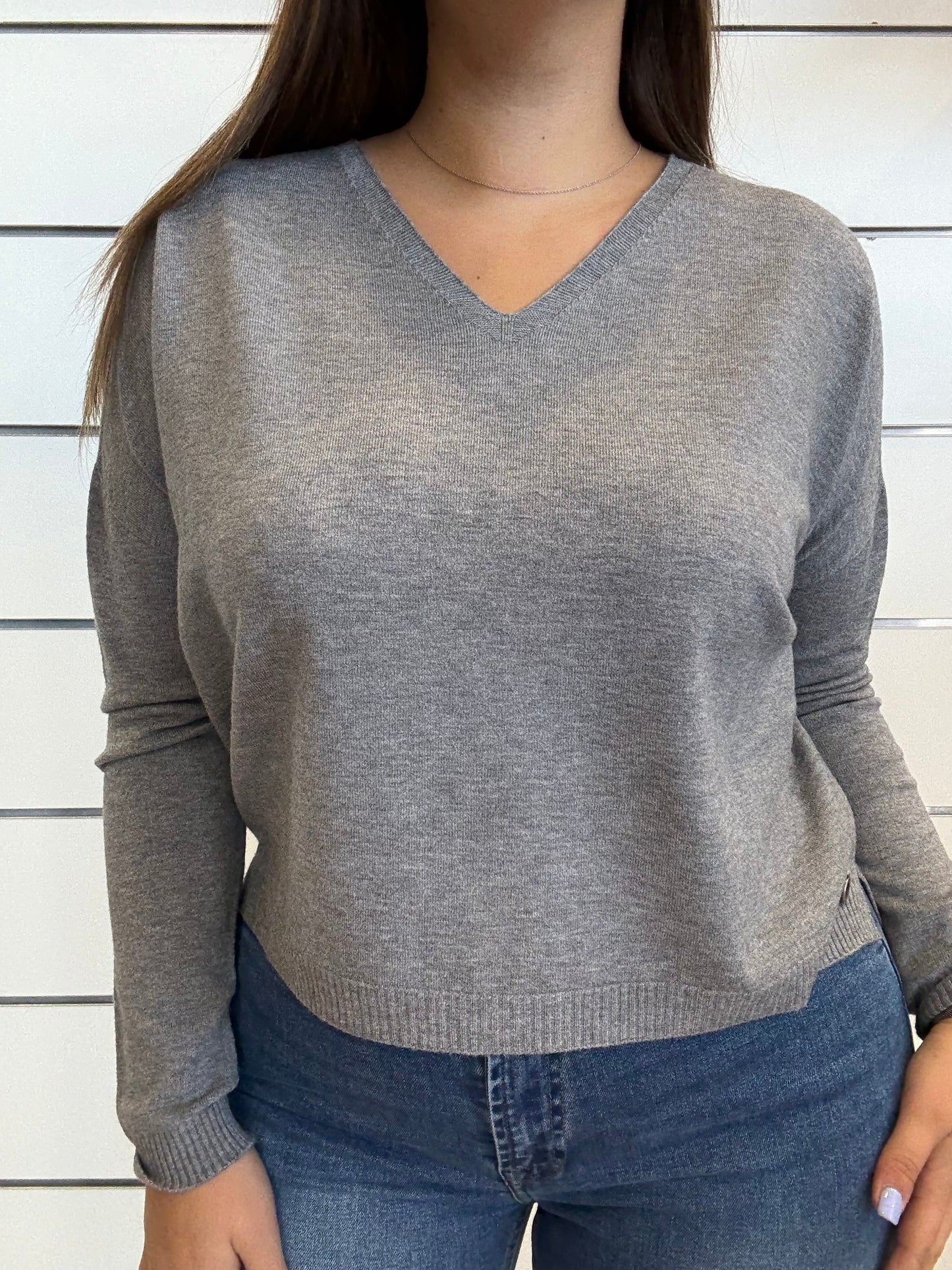 Maglioncino grigio con scollo a 'V' morbido e alla moda, ideale per outfit casual